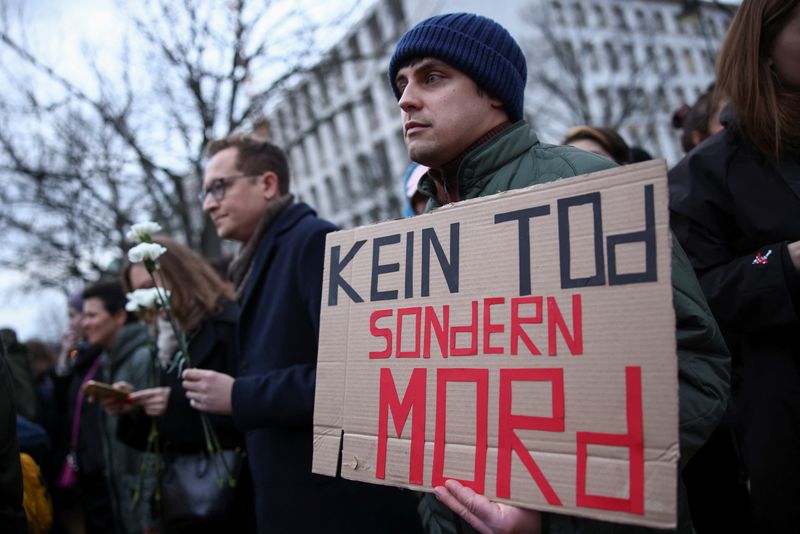 © Reuters. A man holds a placard that reads 