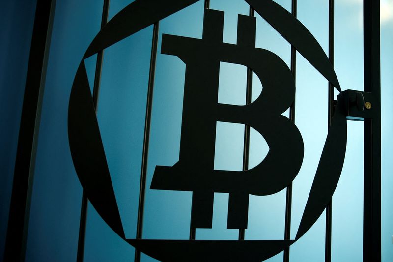 &copy; Reuters. FILE PHOTO: A bitcoin logo is pictured on a door in an illustration picture taken at La Maison du Bitcoin in Paris May 27, 2015. REUTERS/Benoit Tessier/File Photo