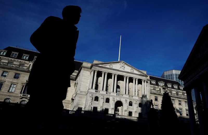 &copy; Reuters. FILE PHOTO: A man is silhouetted as he walks past the Bank of England in the City of London, Britain, December 12, 2017. REUTERS/Clodagh Kilcoyne/File Photo