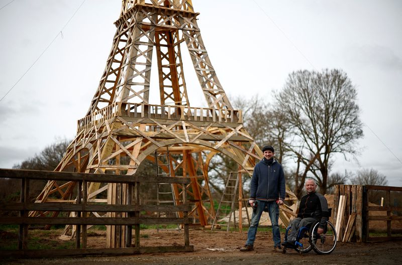 &copy; Reuters. الصديقان الفرنسيان فريدريك مالموزاك وسيلفان بوشار، اللذان يعملان بالنجارة، بجوار نموذجا من الخشب طبق الأصل من برج إيفل بارتفاع 16مترا بفرن