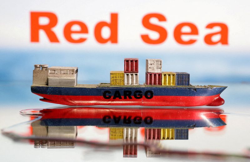 © Reuters. A cargo ship boat model is seen in front of the words 