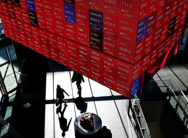 &copy; Reuters. Visitors walk under Japan's Nikkei stock prices quotation board inside a building in Tokyo, Japan February 16, 2024.  REUTERS/Issei Kato /file photo
