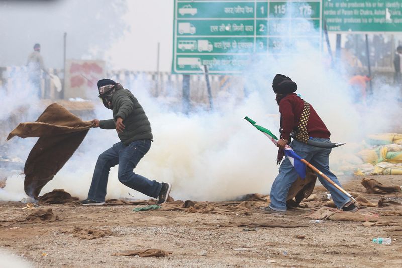 &copy; Reuters. Un agricultor lanza una bolsa de yute mientras se dispara gas lacrimógeno en el lugar de la protesta, mientras los agricultores marchan hacia Nueva Delhi para presionar por mejores precios de las cosechas que se les prometieron en 2021, en la frontera de