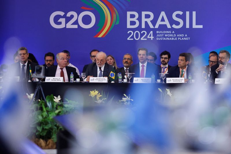 &copy; Reuters. Brazil's President Luiz Inacio Lula da Silva speaks while Brazil's Finance Minister Fernando Haddad and Brazil's Central Bank President Roberto Campos Neto look on during the meeting of the opening of the G20 sherpa and finance tracks joint session in Bra