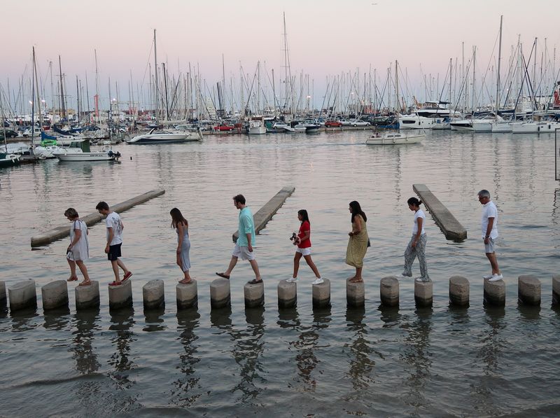 &copy; Reuters. People walk across concrete posts to cross a section of the Marina in Palma de Mallorca, Spain, July 28, 2018.  REUTERS/Paul Hanna/File Photo