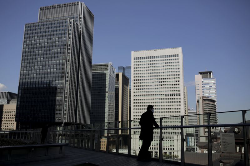 &copy; Reuters. A businessman stands on a terrace overlooking a banking district in Tokyo, Japan, February 16, 2016. The Bank of Japan's negative interest rates came into effect on Tuesday in a radical plan already deemed a failure by financial markets, highlighting Toky