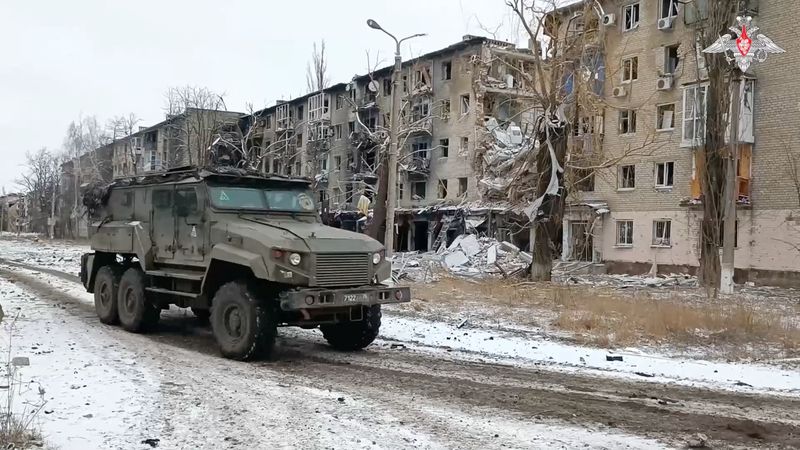 &copy; Reuters. A Russian military vehicle drives past residential buildings damaged in the course of Russia-Ukraine conflict in the town of Avdiivka in the Donetsk Region, Russian-controlled Ukraine, in this image taken from video released February 20, 2024. Russian Def