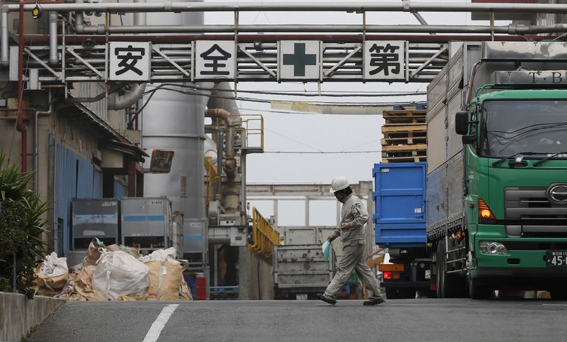 &copy; Reuters. FILE PHOTO: A worker walks at a factory in Tokyo March 29, 2013. REUTERS/Toru Hanai/File Photo