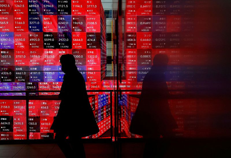 &copy; Reuters. A visitor walks past Japan's Nikkei stock prices quotation board inside a building in Tokyo, Japan February 19, 2024. REUTERS/Issei Kato/file photo