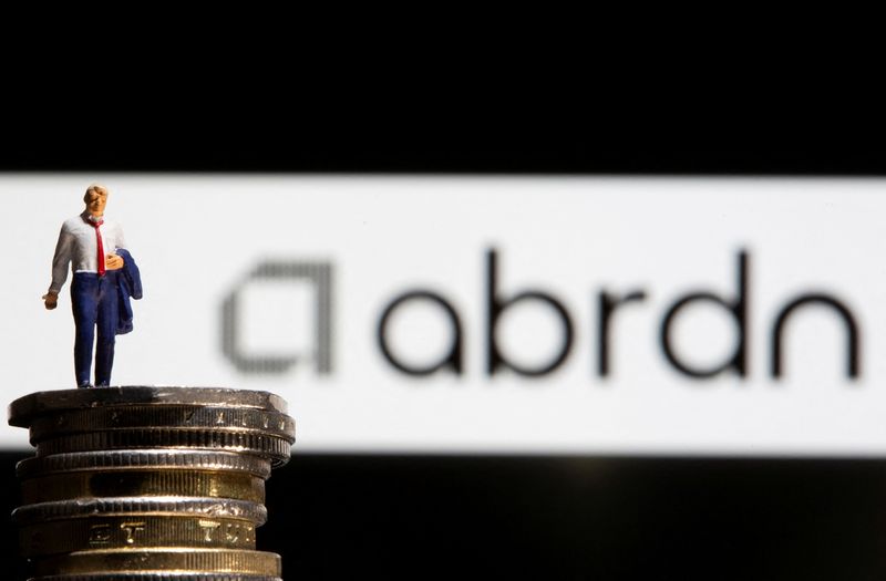 &copy; Reuters. FILE PHOTO: Businessman toy figure is placed on U.K. Pound coins in front of displayed Abrdn logo in this illustration taken, November 8, 2021. REUTERS/Dado Ruvic/Illustration/File Photo