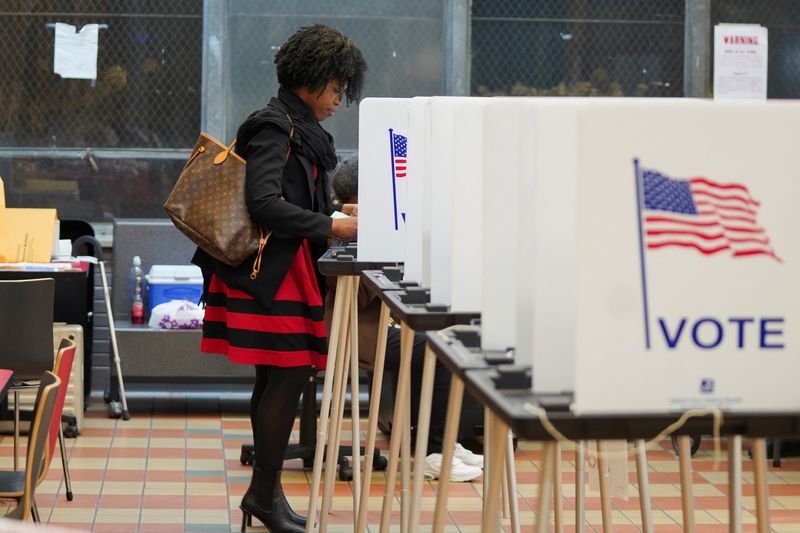 &copy; Reuters. FILE PHOTO: A woman votes at a voting site as Democrats and Republicans hold their Michigan primary presidential election, in Detroit, Michigan, U.S. February 27, 2024. REUTERS/Dieu-Nalio Chery/File Photo