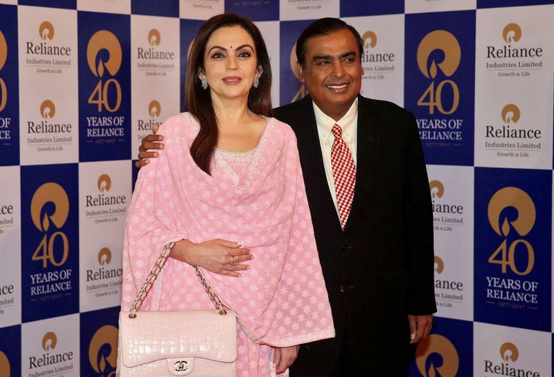 &copy; Reuters. FILE PHOTO: Mukesh Ambani, Chairman and Managing Director of Reliance Industries, poses with wife Nita Ambani before addressing the company's annual general meeting in Mumbai, India July 21, 2017. REUTERS/Shailesh Andrade/File Photo