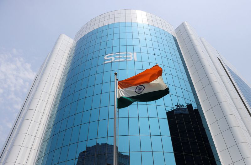 &copy; Reuters. FILE PHOTO: The Indian flag flies in front of the new logo of the Securities and Exchange Board of India (SEBI) at its headquarters in Mumbai, India, April 19, 2023. REUTERS/Francis Mascarenhas/File Photo
