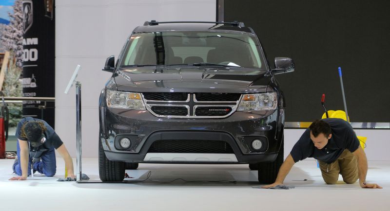 &copy; Reuters. FILE PHOTO: Workers clean tire marks on the floor around a 2019 Dodge Journey during the media day at the Canadian International AutoShow in Toronto, Ontario, Canada, February 14, 2019. REUTERS/Chris Helgren/File Photo