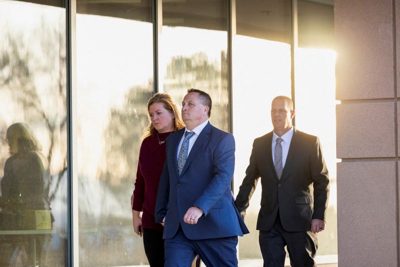 © Reuters. FILE PHOTO: Paramedics Jeremy Cooper and Peter Cichuniec leave the Adams County District Court while a jury deliberates in a trial where they are accused in the death of Elijah McClain, an unarmed Black man who died in police custody in 2019 after he was subdued and injected with a sedative, in Brighton, Colorado, U.S., December 22, 2023.  REUTERS/Kevin Mohatt/File Photo