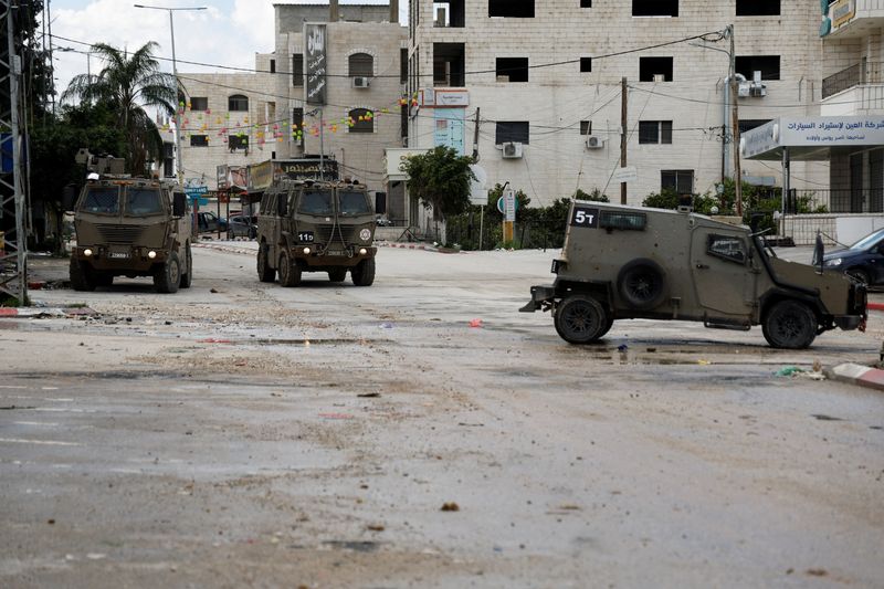 &copy; Reuters. FILE PHOTO: Military vehicles stand on a street during an Israeli raid at Tulkarm, in the Israeli-occupied West Bank, February 18, 2024. REUTERS/Raneen Sawafta/File Photo