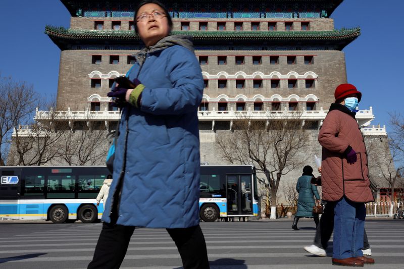 &copy; Reuters. Pedestrians walk on a crossing near the Qianmen Gate in Beijing, China January 26, 2024. REUTERS/Florence Lo/file photo