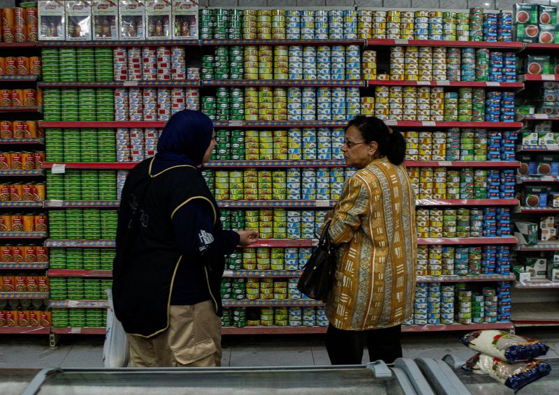 &copy; Reuters. FILE PHOTO: Egyptian women talk as they buy subsidized food commodities at a consumer association market or "Government-run supermarket" amid high prices of consumer goods in Cairo, Egypt, December 4, 2023. REUTERS/Shokry Hussien/File Photo