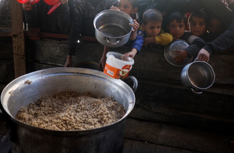 &copy; Reuters. Des enfants palestiniens attendent de recevoir de la nourriture préparée par une cuisine caritative, alors que le conflit entre Israël et le groupe islamiste palestinien Hamas se poursuit, à Rafah, dans le sud de la bande de Gaza. /Photo prise le 5 ma