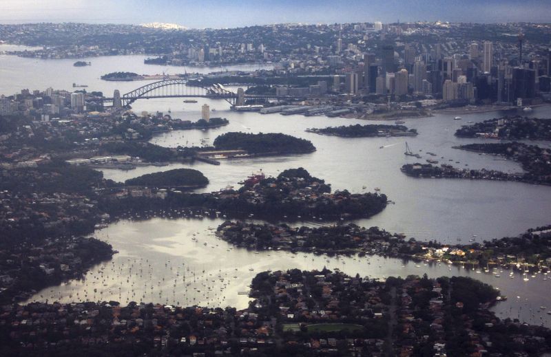 &copy; Reuters. The Sydney Harbour Bridge and Central Business District (CBD) can be seen behind houses along the foreshore of Sydney Harbour, in this aerial picture taken February 1, 2016.  REUTERS/David Gray      