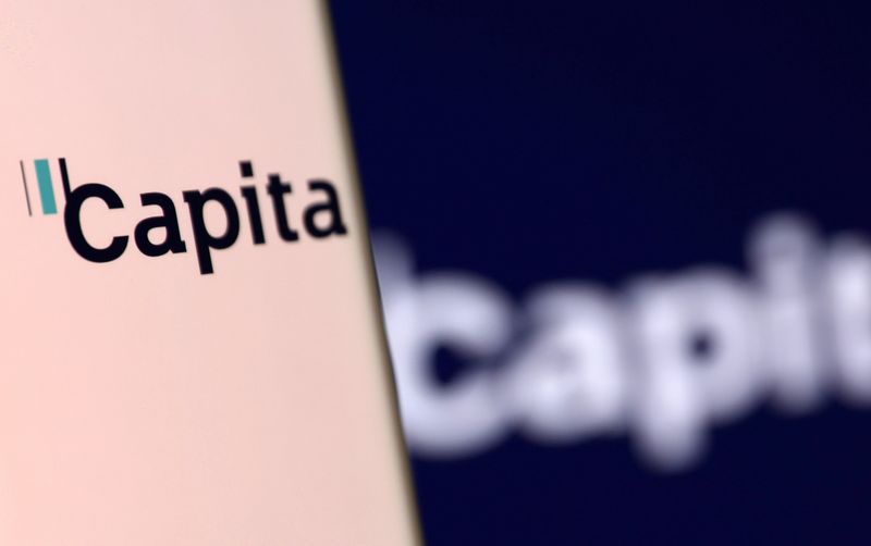 &copy; Reuters. File photo: Capita's logo is pictured on a smartphone in front of an electronic display showing the same logo in this illustration taken, December 4, 2021. REUTERS/Dado Ruvic/Illustration/File photo
