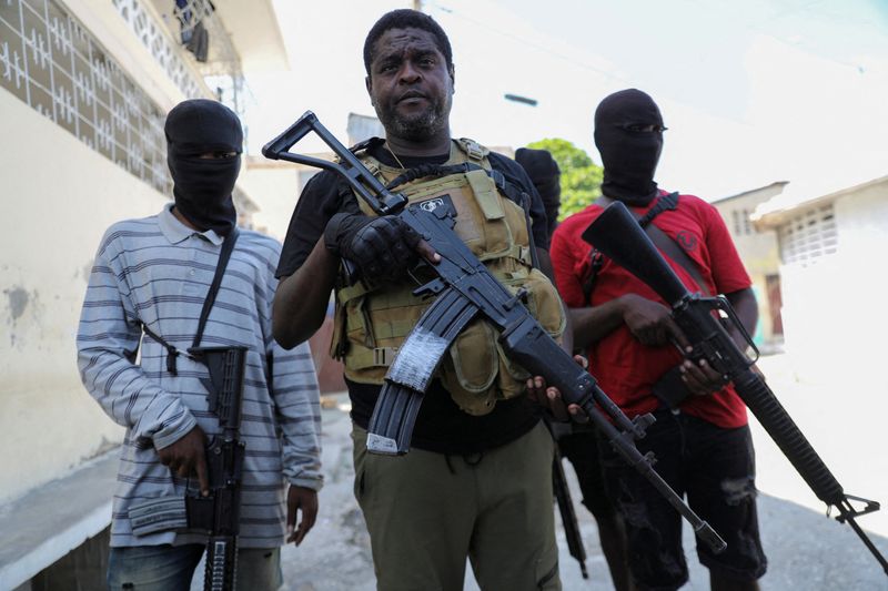 &copy; Reuters. FILE PHOTO: Former police officer Jimmy "Barbecue" Cherizier, leader of the 'G9' gang alliance, is flanked by gang members after a press conference in Delmas 6, Port-au-Prince, Haiti March 5, 2024. REUTERS/Ralph Tedy Erol/File Photo