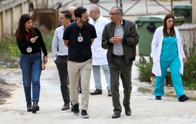 &copy; Reuters. The Middle East chief of The International Committee of the Red Cross, Fabrizio Carboni, chats with  director of Marjayoun Hospital, Mounes Klakesh, as they walk outside the hospital in Marjayoun, near the border with Israel, southern Lebanon March 6, 202