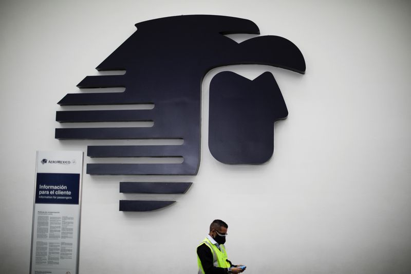 &copy; Reuters. Imagen de archivo. Un empleado camina frente al logo de la aerolínea mexicana Aeroméxico en el aeropuerto internacional Benito Juárez en Ciudad de México, México. 1 de febrero de 2022. REUTERS/Luis Cortés