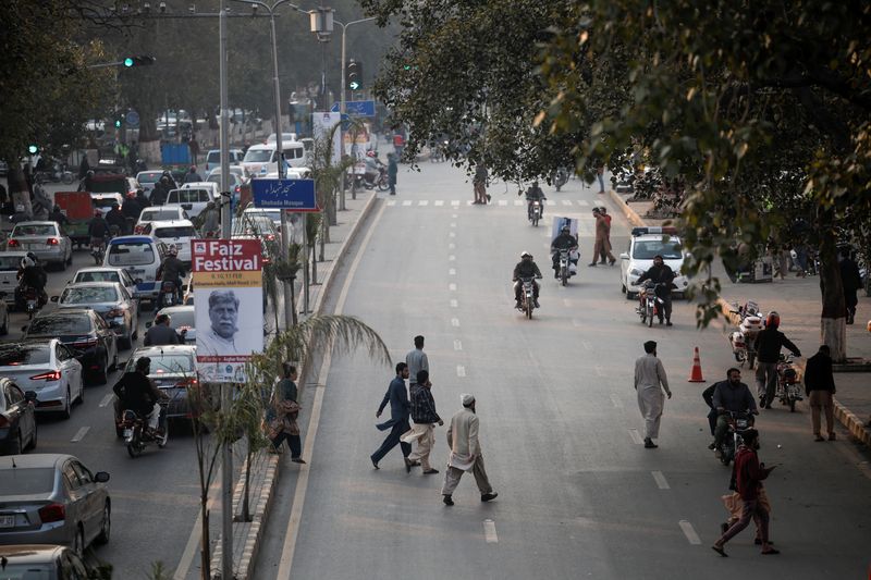 &copy; Reuters. People cross a street as the rally of supporters of the Tehreek-e-Labbaik Pakistan (TLP), a religious and political party, demanding free and fair results of the election, approaches the Mall Road in Lahore, Pakistan February 10, 2024. REUTERS/Navesh Chit