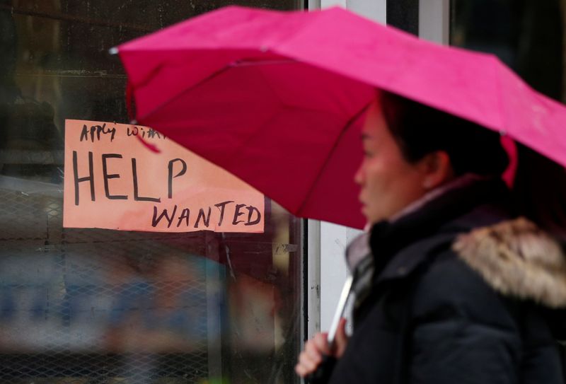 &copy; Reuters. FILE PHOTO: A woman walks past a "Help wanted" sign at a retail store in Ottawa, Ontario, Canada, November 2, 2017. REUTERS/Chris Wattie/File Photo