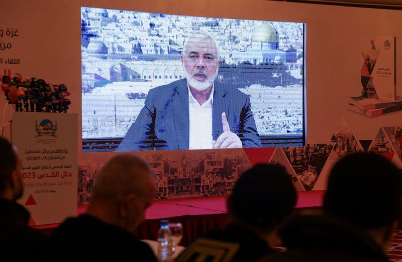 &copy; Reuters. FILE PHOTO: Hamas leader, Ismail Haniyeh, speaks in a pre-recorded message shown on a screen during a press event for Al Quds International Institution in Beirut, Lebanon February 28, 2024. REUTERS/Mohamed Azakir/File Photo