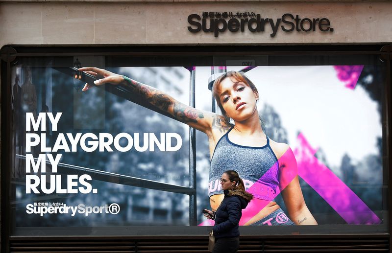 &copy; Reuters. FILE PHOTO: A woman walks past a window display at a Superdry store in London, Britain, March 1, 2019. REUTERS/Toby Melville/File Photo
