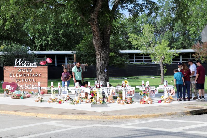 &copy; Reuters. FILE PHOTO: People visit a memorial for the 21 victims of a mass shooting at Robb Elementary School, one year after the shooting, in Uvalde, Texas, U.S., May 24, 2023. REUTERS/Evan Garcia/File Photo