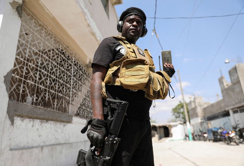 &copy; Reuters. FILE PHOTO: Former police officer Jimmy "Barbecue" Cherizier, and leader of an alliance of armed groups, speaks to a news outlet on a mobile phone during a news conference, in Port-au-Prince, Haiti, March 11, 2024. REUTERS/Ralph Tedy Erol/File Photo