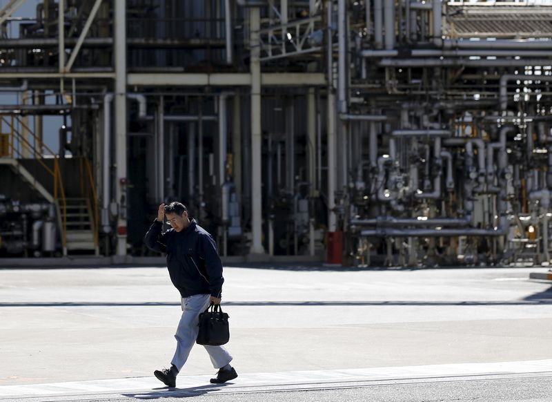 &copy; Reuters. A worker walks past a factory at the Keihin industrial zone in Kawasaki, Japan February 17, 2016.   REUTERS/Toru Hanai/file photo