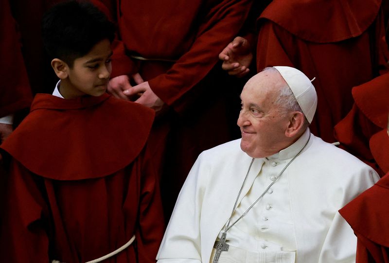 &copy; Reuters. Pope Francis smiles to a young member of a choir on the day of the weekly general audience, in Paul VI hall at the Vatican, February 28, 2024. REUTERS/Yara Nardi/File Photo     