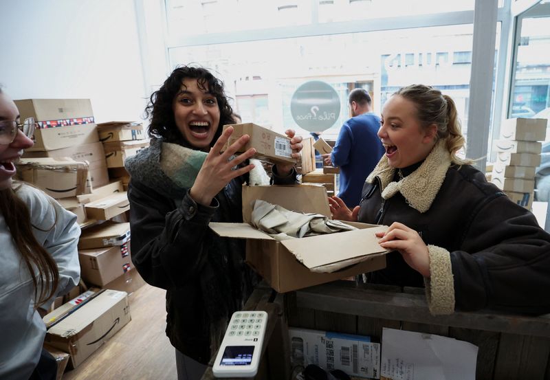 &copy; Reuters. Belgian Chloe Boseret, 20, Moroccan Hiba Did, 20 and French Anouk Anglade react after opening a parcel at "Pile ou Face", a shop that sells still-sealed packages, which were lost during delivery or remained uncollected at the post office, by the kilo, wit