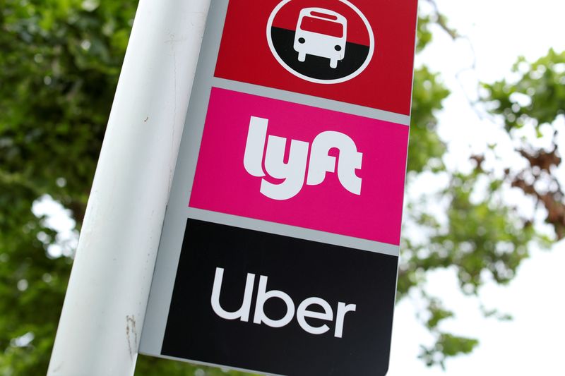 &copy; Reuters. A sign marks a rendezvous location for Lyft and Uber users at San Diego State University in San Diego, California, U.S., May 13, 2020. REUTERS/Mike Blake/File Photo