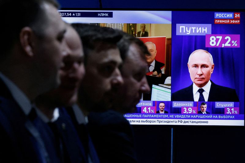 &copy; Reuters. Hombres sentados cerca de un televisor que transmite noticias sobre los resultados del candidato presidencial ruso y presidente en ejercicio Vladimir Putin, el último día de las elecciones presidenciales en Moscú, Rusia, el 17 de marzo de 2024. REUTERS