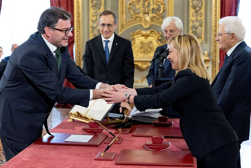&copy; Reuters. FILE PHOTO: Italy's new Economy Minister Giancarlo Giorgetti shakes hands with Italy's Prime Minister Giorgia Meloni during the swearing-in ceremony at the Quirinale Presidential Palace, in Rome, Italy October 22, 2022. Italian Presidency/Handout via REUT