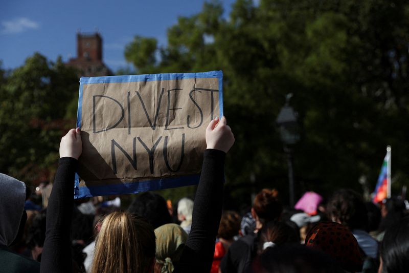 &copy; Reuters. FILE PHOTO: A person holds a sign as people attend a demonstration to express solidarity with Palestinians in Gaza, amid the ongoing conflict between Israel and Hamas, as part of a student walkout by students of New York University, in New York City, U.S.