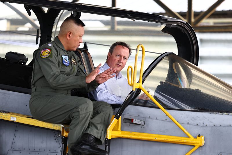 &copy; Reuters. El ministro británico de Asuntos Exteriores y ex primer ministro, David Cameron, habla con un piloto mientras se sienta en la cabina de un caza Gripen, al margen de una entrevista con Reuters en una base de la Fuerza Aérea en la provincia de Nakhon Ratc