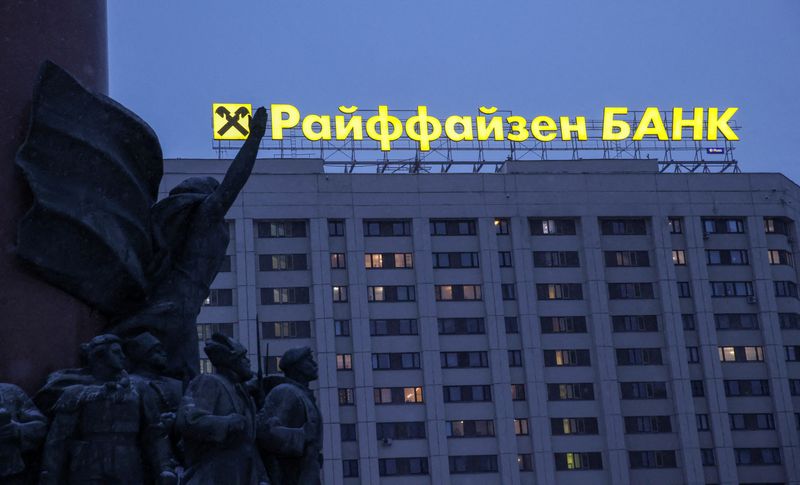&copy; Reuters. FILE PHOTO: A signboard advertising Raiffeisen Bank is seen behind figures of the 1917 Bolshevik Revolution participants, which form a fragment of a monument to Soviet state founder Vladimir Lenin, in Moscow, Russia, February 11, 2023. REUTERS/Tatyana Mak