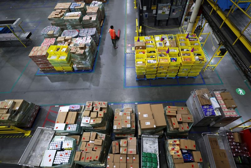 &copy; Reuters. FILE PHOTO: A worker stands amid stacks of products during Cyber Monday at the Amazon's fulfillment center in Robbinsville, New Jersey, U.S., November 27, 2023. REUTERS/Mike Segar/File Photo