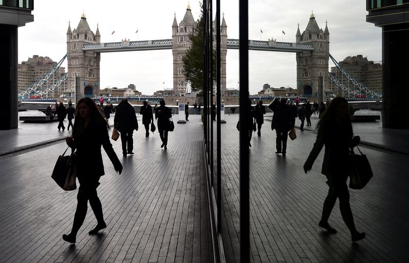 &copy; Reuters. FILE PHOTO: Workers walk through the More London business district with Tower Bridge seen behind in London, November 11, 2015.  REUTERS/Toby Melville/File Photo/File Photo