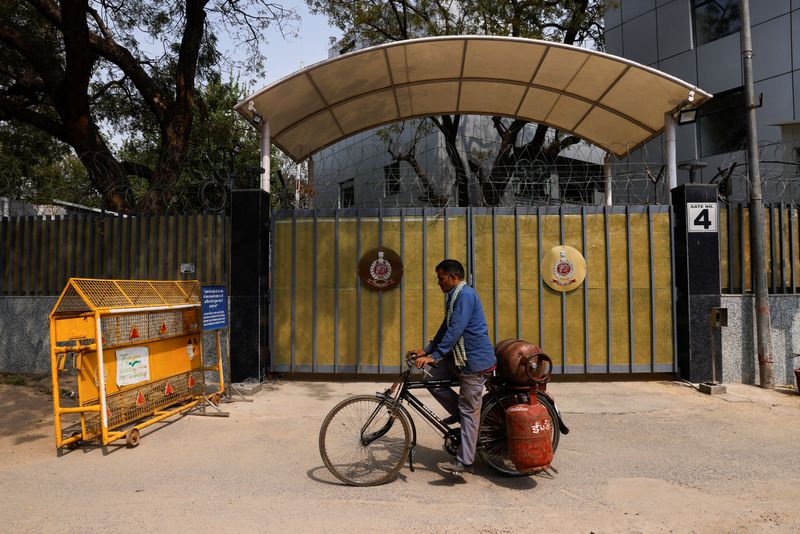 &copy; Reuters. A man on a bicycle rides past a gate of the office of Directorate of Enforcement in New Delhi, India, March 13, 2024. REUTERS/Anushree Fadnavis