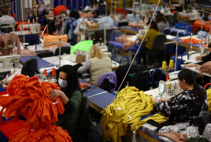 &copy; Reuters. Machinists are seen at work on the factory floor of Fashion-Enter Ltd in London, Britain, February 15, 2023. REUTERS/Hannah McKay/File Photo