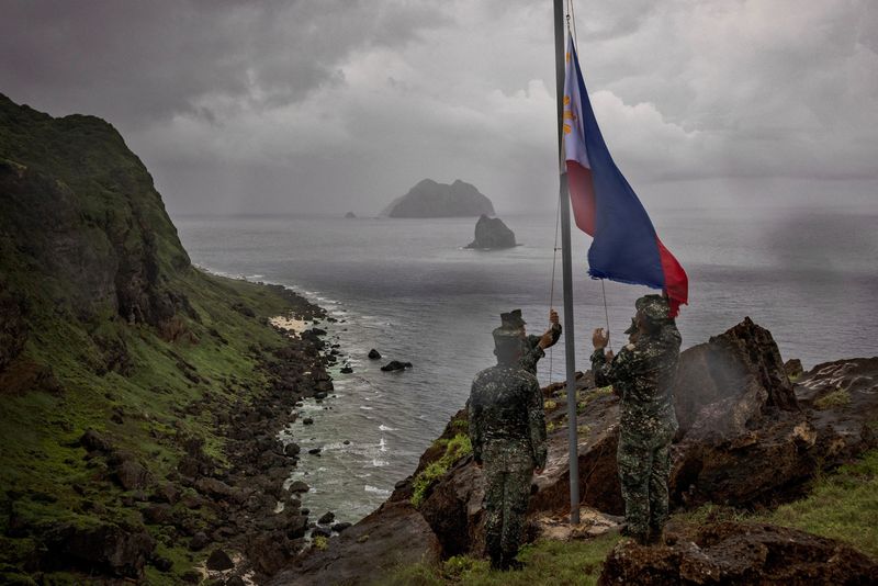 &copy; Reuters. FILE PHOTO: Filipino soldiers take part in a flag raising ceremony on Mavulis Island during a trip of the chief of staff of the Armed Forces of the Philippines, in Batanes, Philippines, June 29, 2023. Batanes, a group of idyllic islands at the country’s