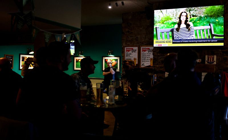 &copy; Reuters. People watch Sky News in The Thistleberry Hotel, as a video is shown in which Britain's Catherine, Princess of Wales, announced she is undergoing preventative chemotherapy after tests taken following abdominal surgery in January revealed cancer had been p