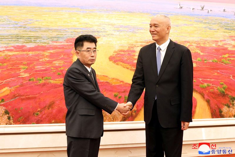 © Reuters. North Korea's Kim Song Nam, an alternate member of the Political Bureau and head of the International Department of the Workers' Party of Korea, and Cai Qi, head of the Secretariat of the Chinese Communist Party, shake hands at the Great Hall of the People in Beijing, China, March 22, 2024. KCNA via REUTERS